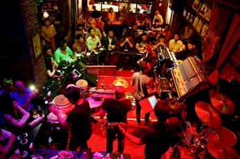 A vibrant event space filled with people enjoying a live performance.