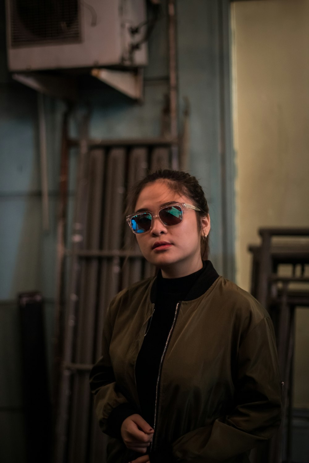 woman wearing sunglasses and brown jacket