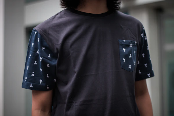An adult comfortably wearing a t-shirt with stretch panels for enhanced mobility.