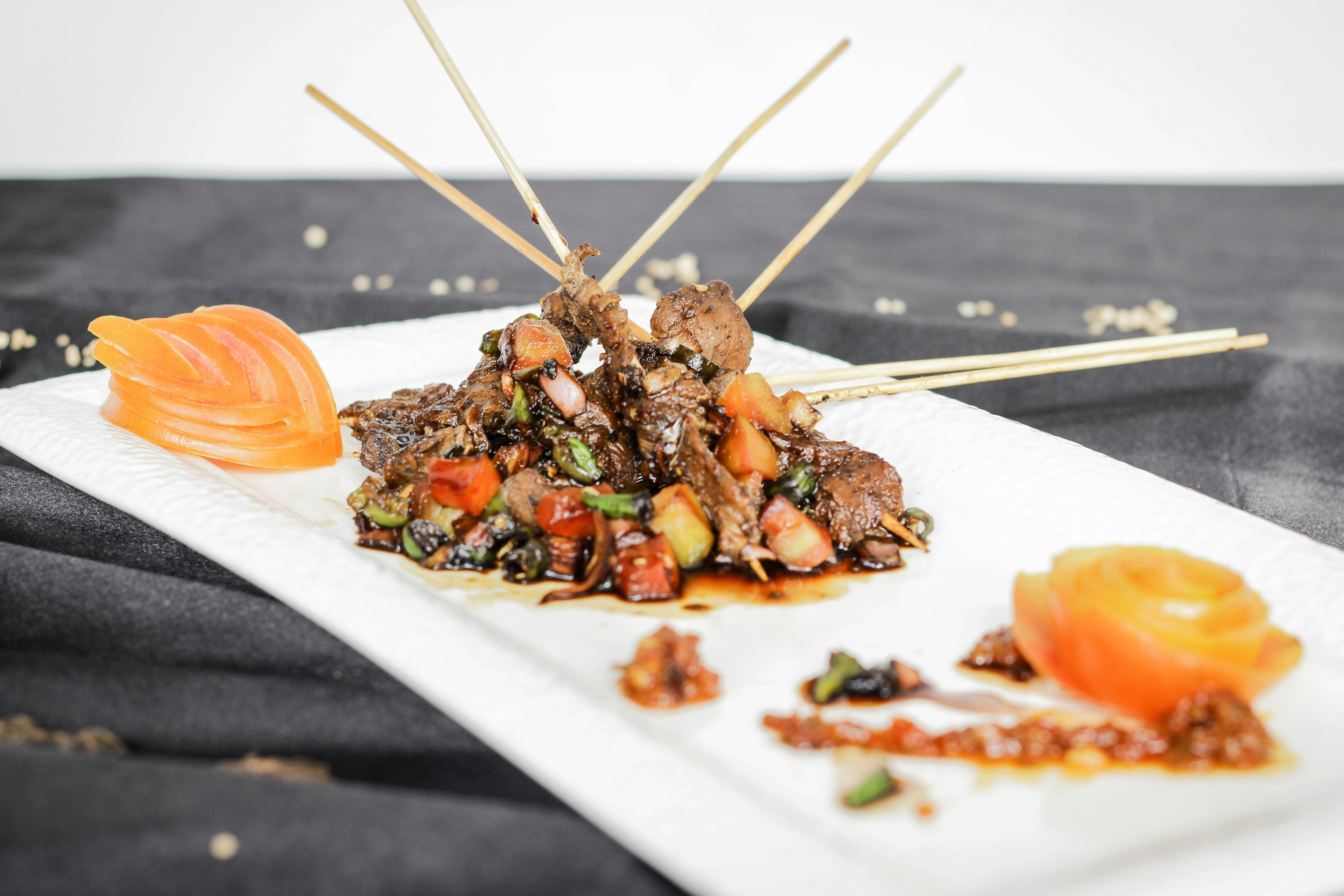Plated skewers with garnish on white