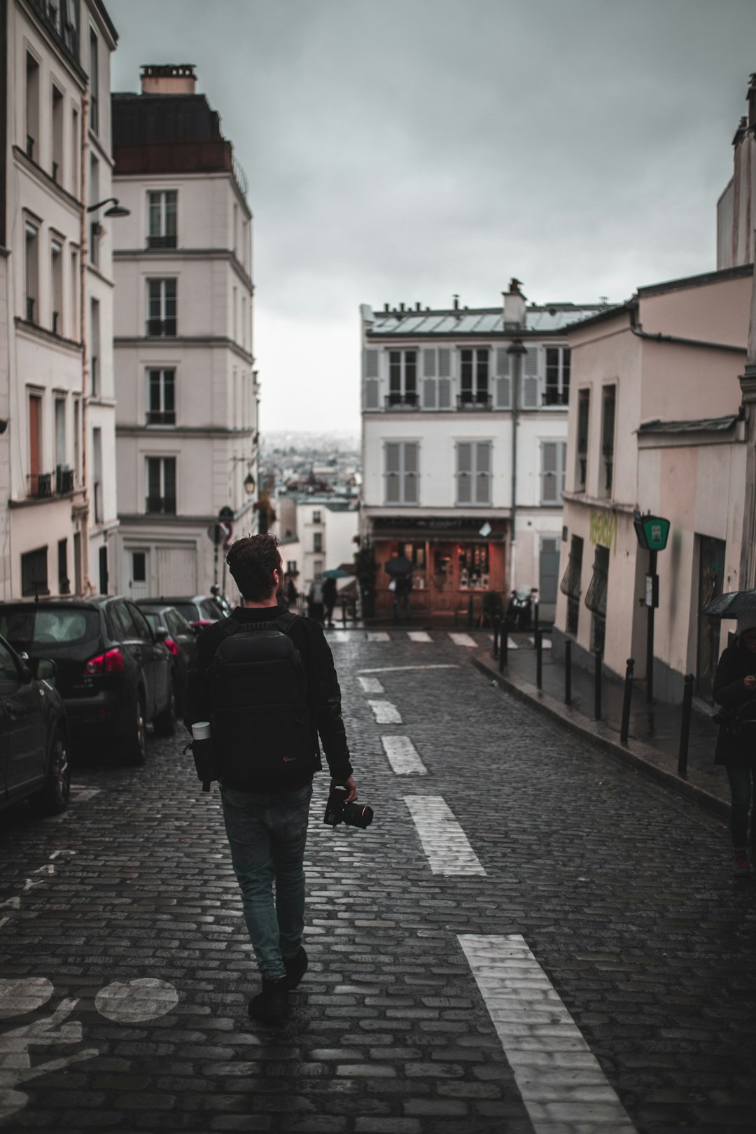 man walking on road near houses