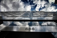 An artistic depiction of the number 666 intertwined with geometric shapes and ancient script.