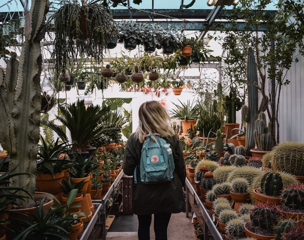 woman standing inside plant shop during daytime