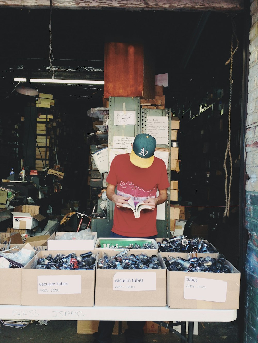 man standing beside boxes