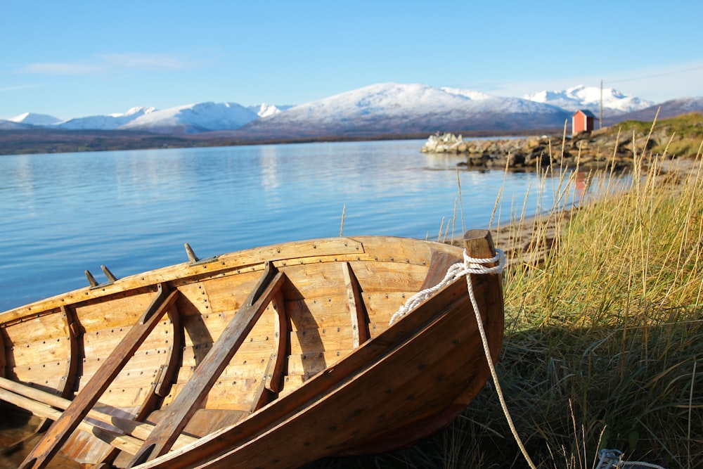 brown wooden boat on shore