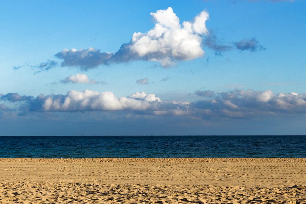 seashore under blue sky during daytime