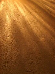 A golden-hued rustic texture reminiscent of ancient manuscripts, softly glowing.