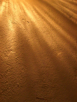 A golden-hued rustic texture reminiscent of ancient manuscripts, softly glowing.