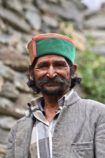 A warm portrait of Manjunath Makkalgeri engaging with villagers during a community health camp.