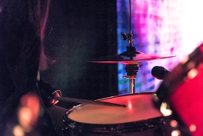 person playing drums drumstick google meet background