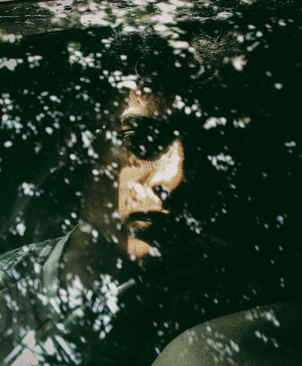 close-up photography of man sitting inside vehicle