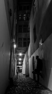 A moody, crimson-lit alleyway with a sleek camera setup ready for a shoot.