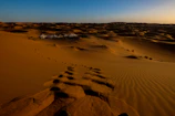 A luxury desert glamping tent nestled among the golden dunes of Sharqiya Sands.