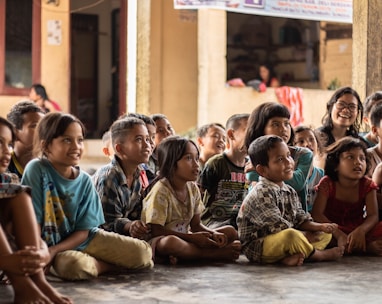 group of childrens sitting on ground