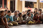 group of childrens sitting on ground