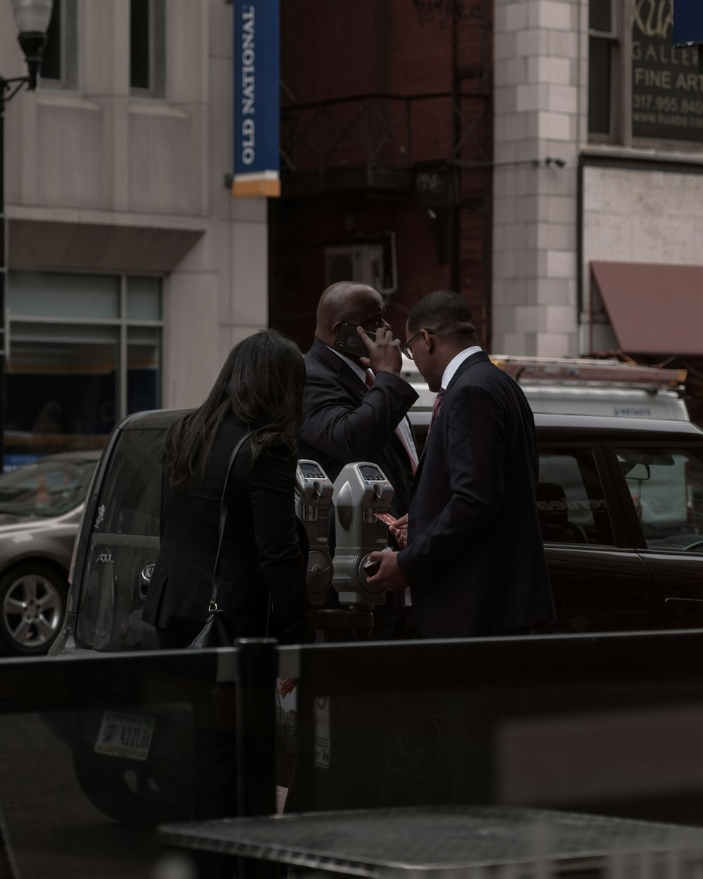 three people standing outside the building