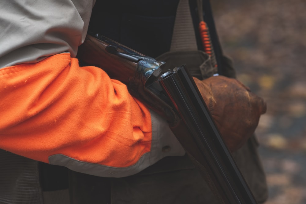 selective focus photography of person reloading rifle