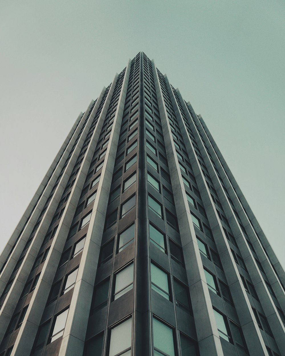 low angle photography of gray high rise building