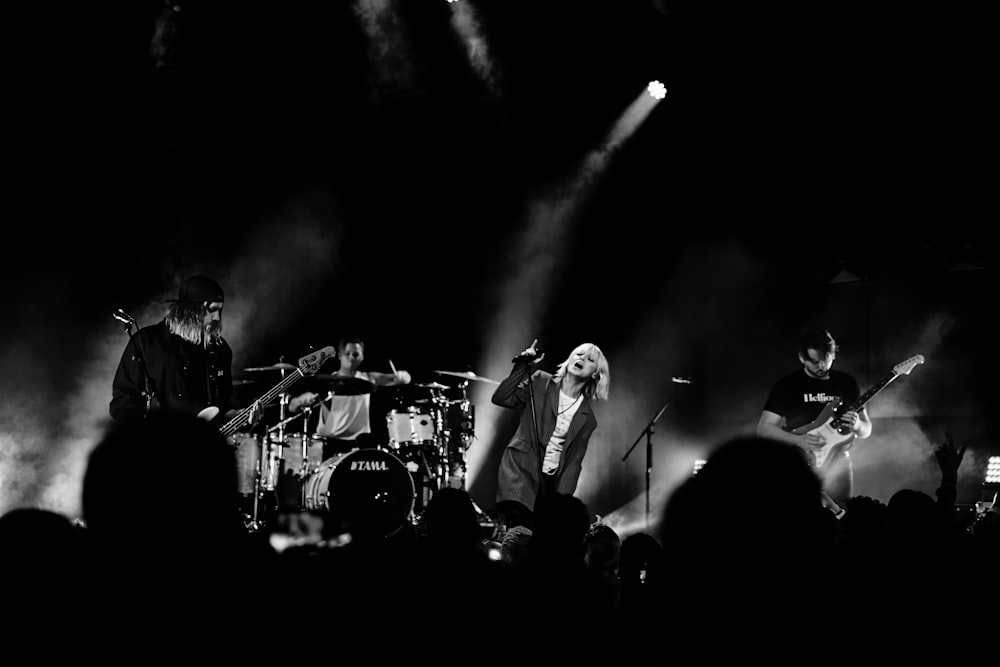 grayscale photography of band performing on stage
