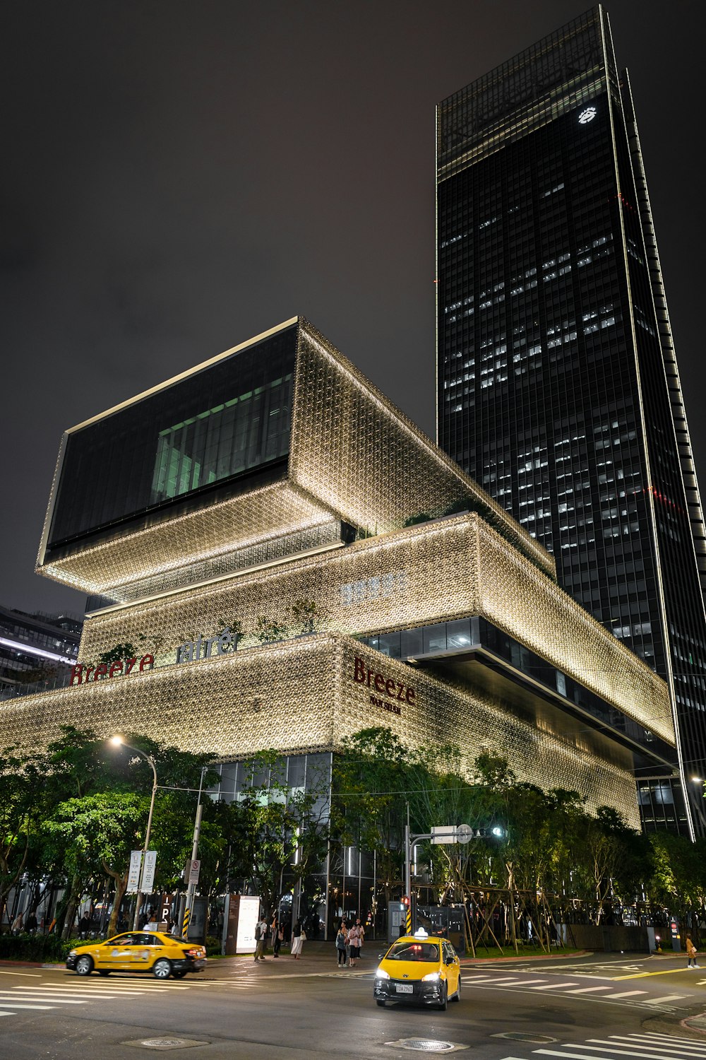 concrete building near road at night time