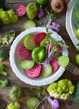 Healthy meal with fresh vegetables and grains on a rustic table.