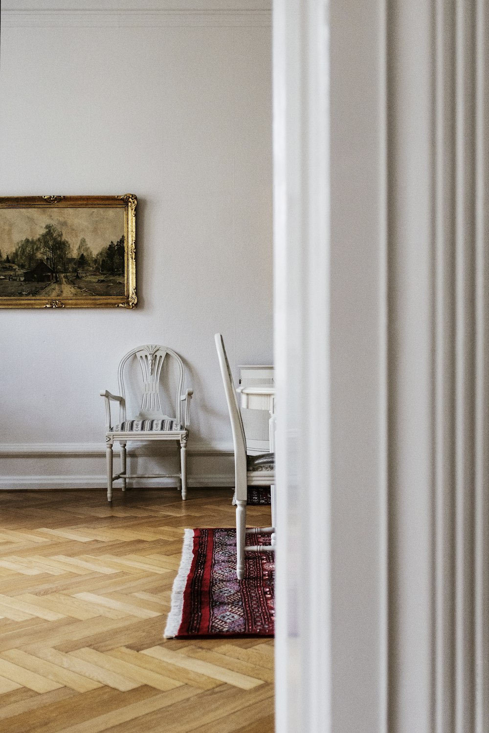 empty armchair by wall near dining table