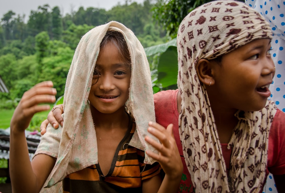 smiling girl seated near another girl