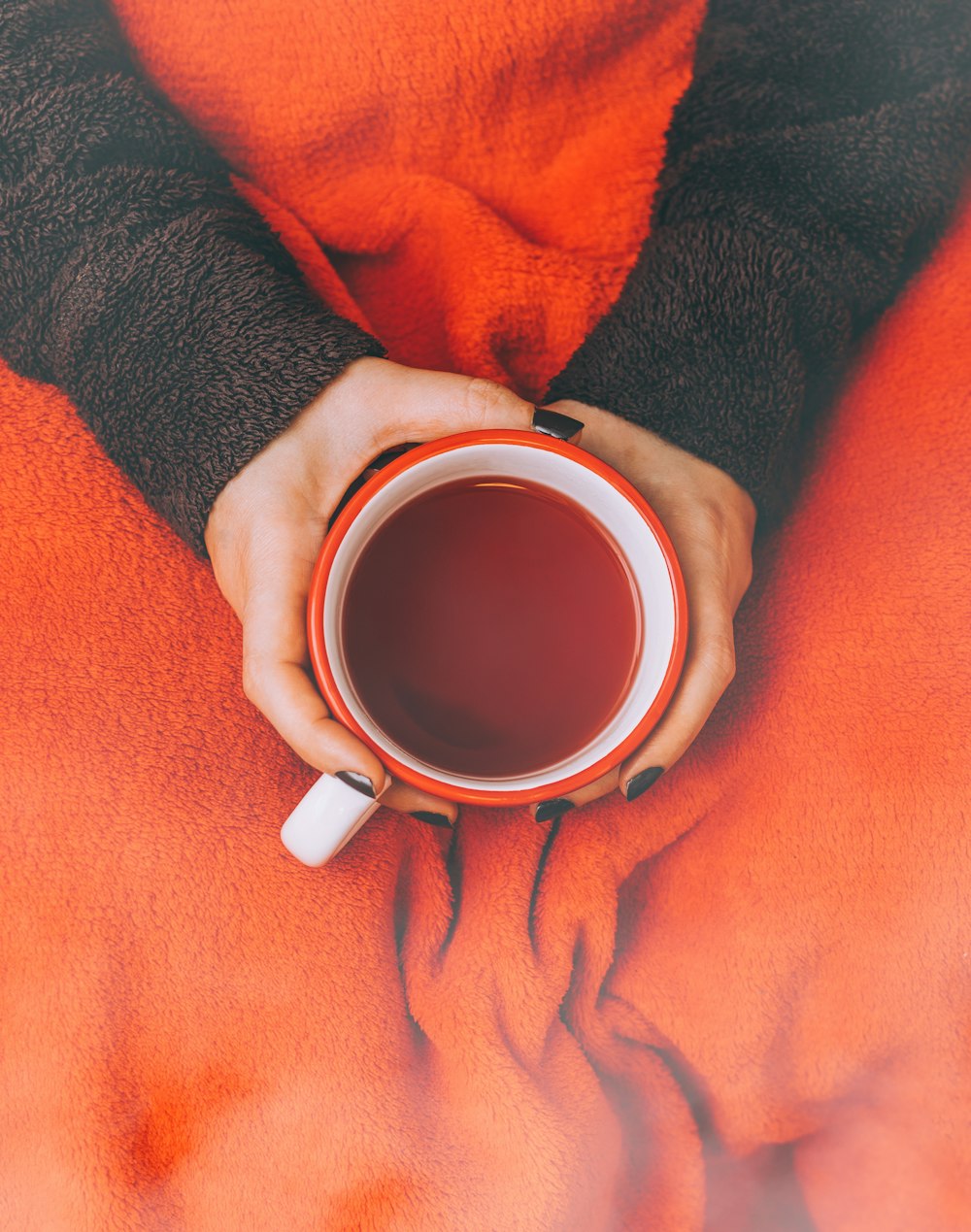 person holding red cup