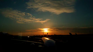 A serene airport runway at sunset symbolizing smooth flight planning