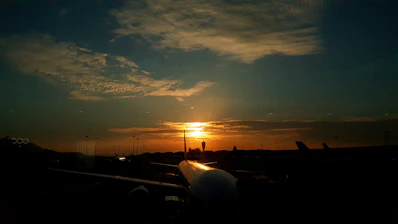 A serene airport runway at sunset symbolizing smooth flight planning