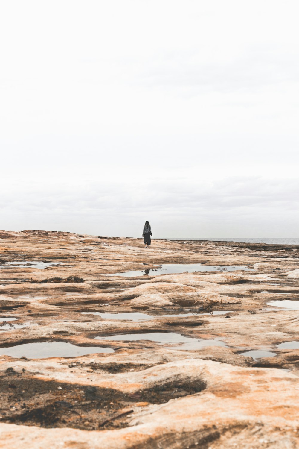 silhouette of person under white clouds