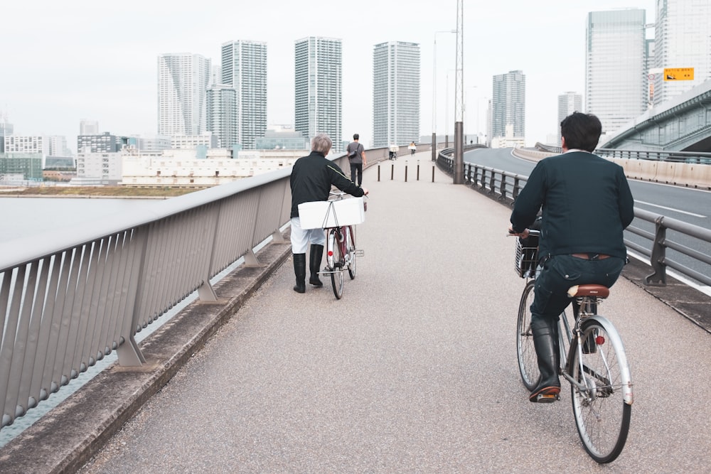 two person riding bicycle near ocean