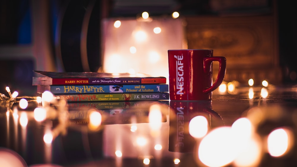 Nescafe mug beside story books