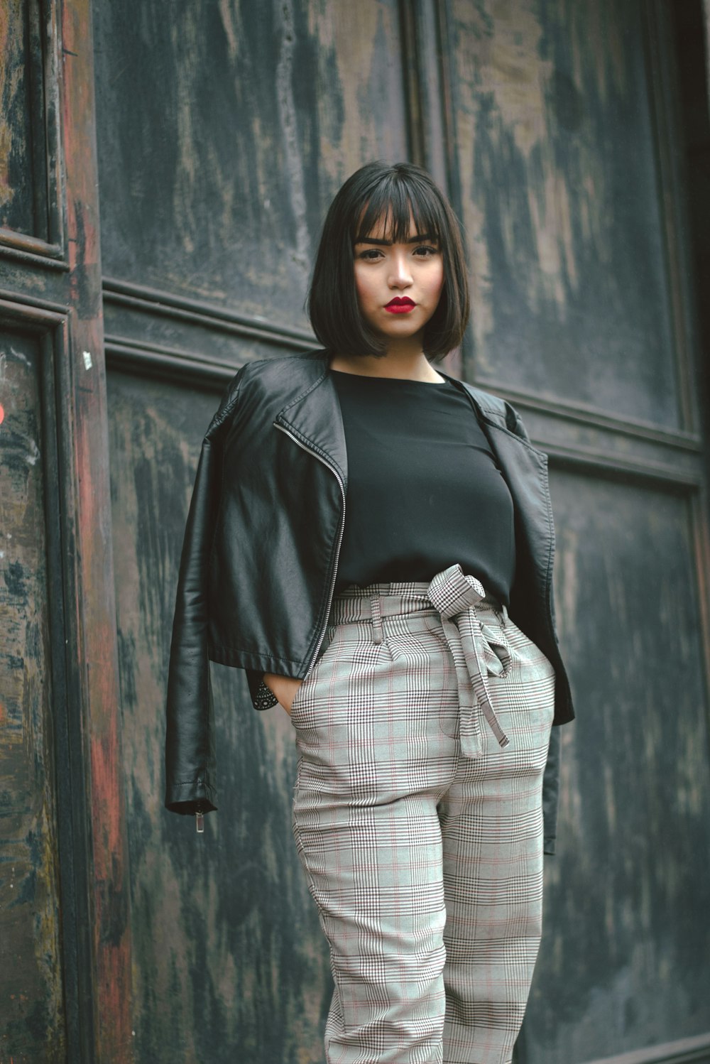 woman wearing black blazer standing near wall