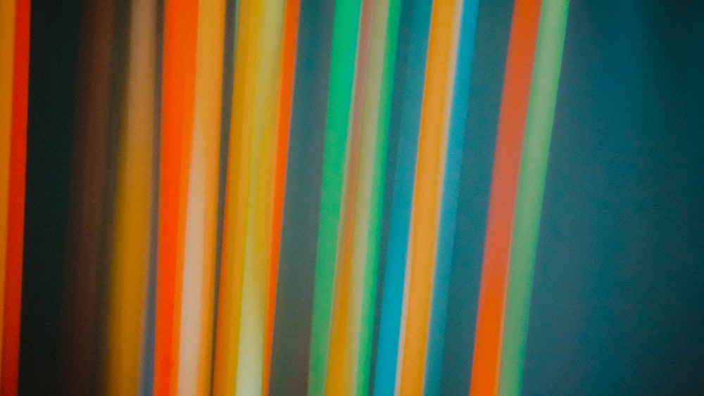 a group of multicolored sticks in a room