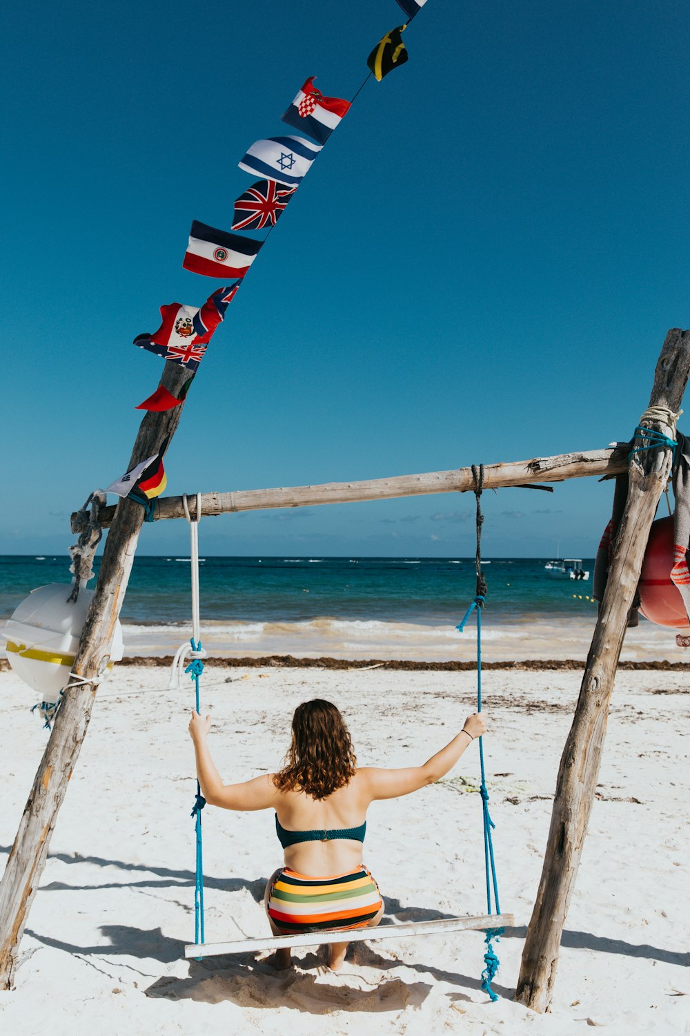 woman sitting on brown wooden swing bench