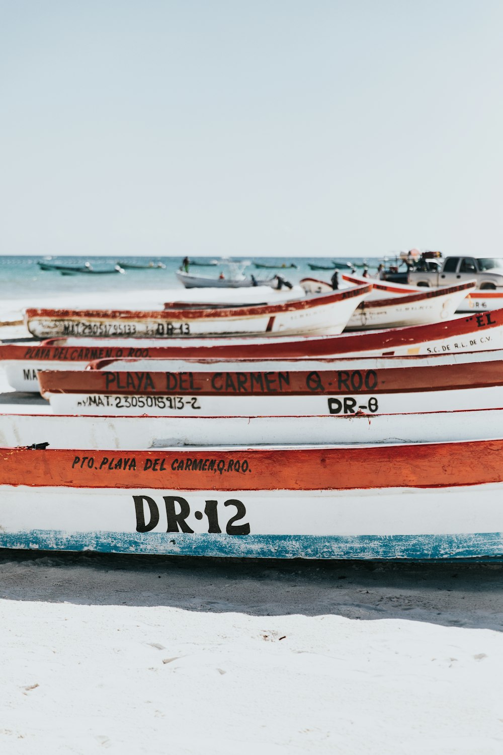 assorted-color boat lot on shore during daytime