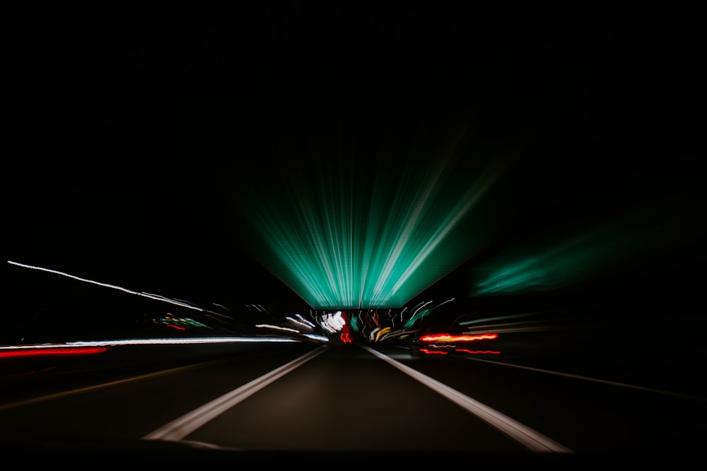 time-lapse photography of vehicle on black top-road at night