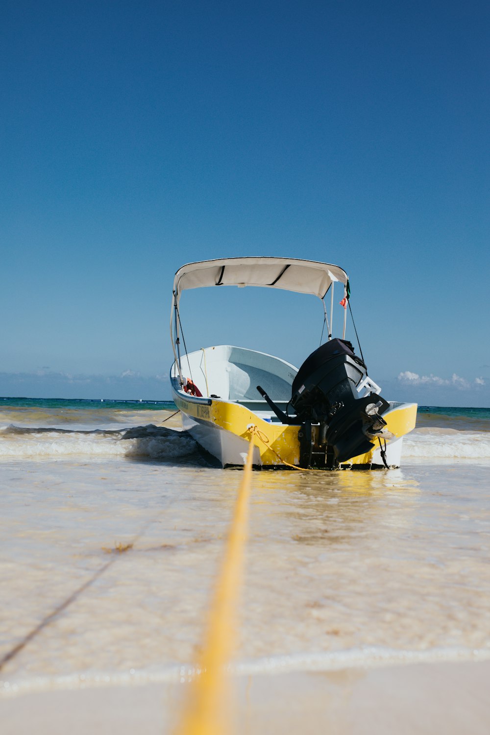 white speedboat on shore at daytime