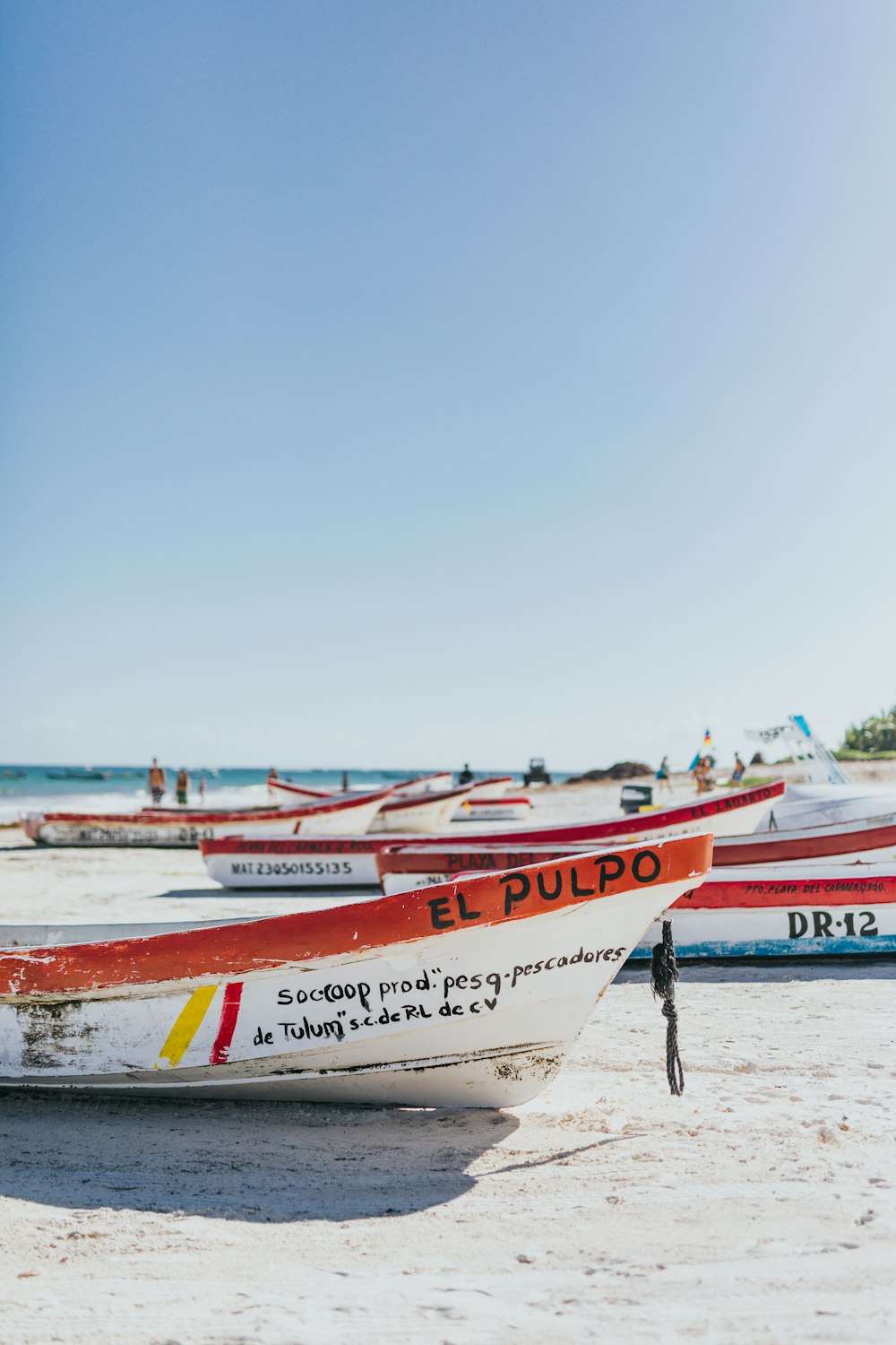 white and red boat near ocean