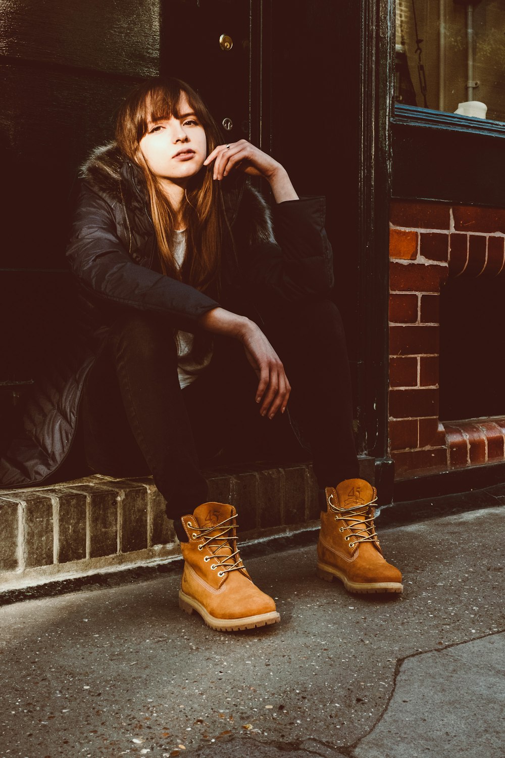 woman sitting near door