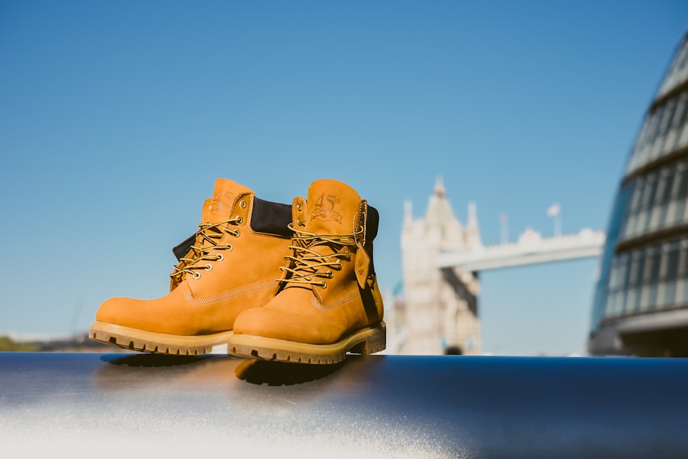 selective focus photography of pair of brown leather work boots