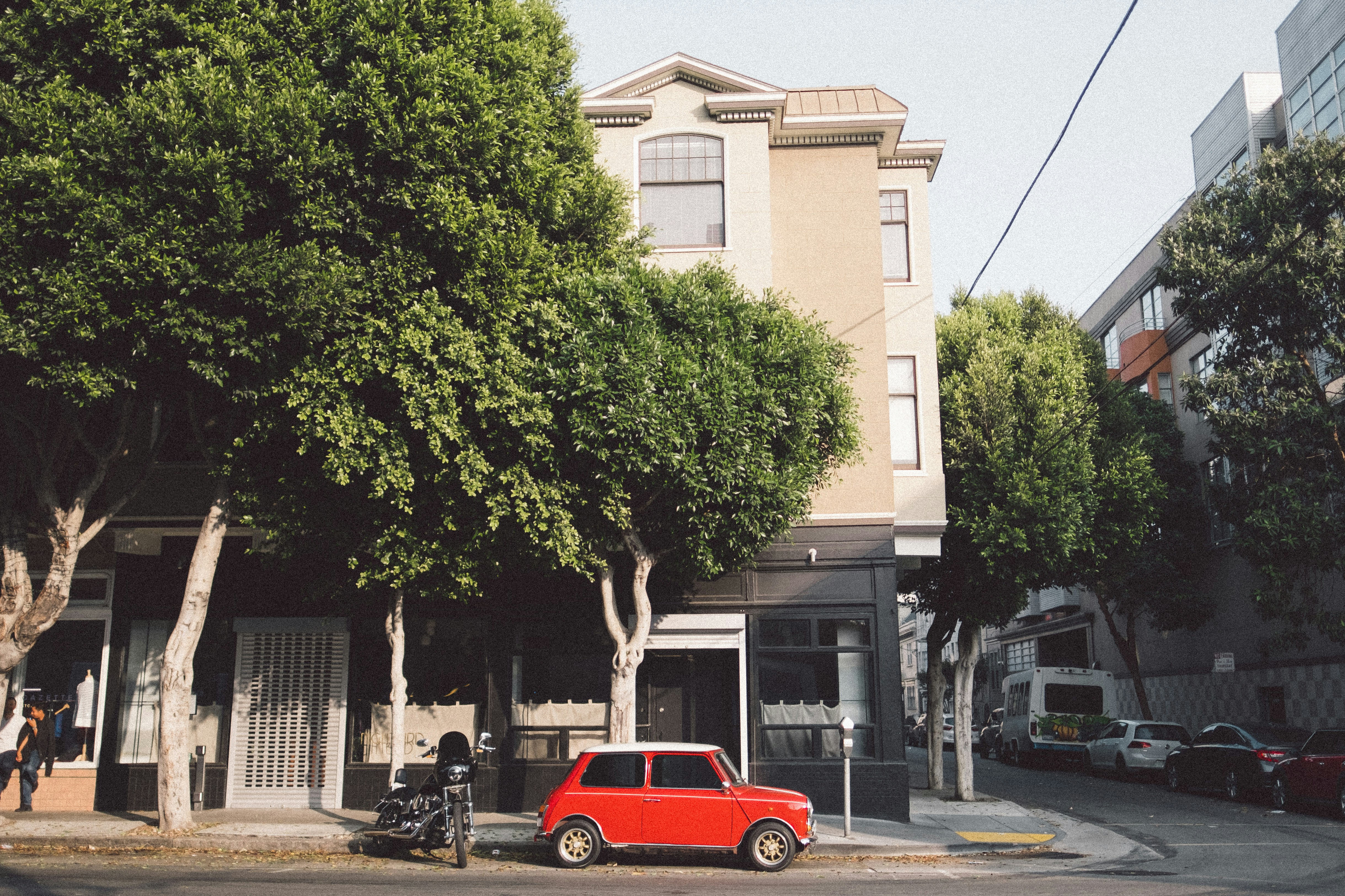 A neighborhood electric vehicle parked on a low-speed residential street