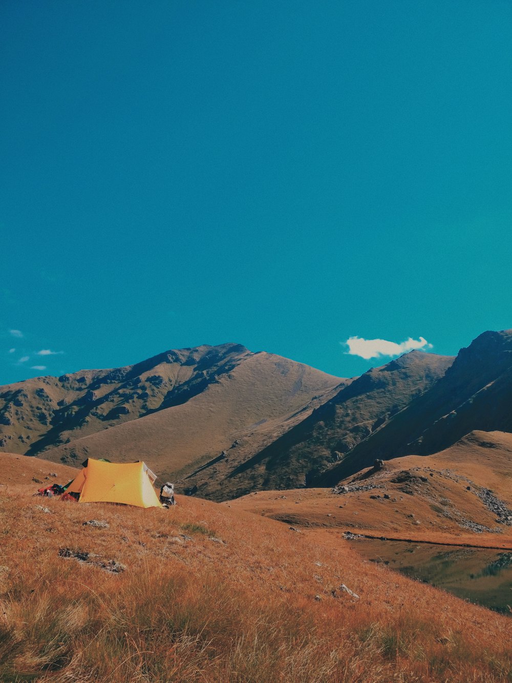 orange tent on mountain