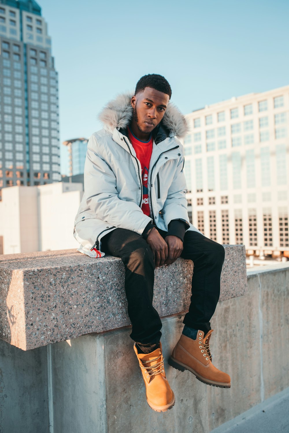 man sitting on concrete block