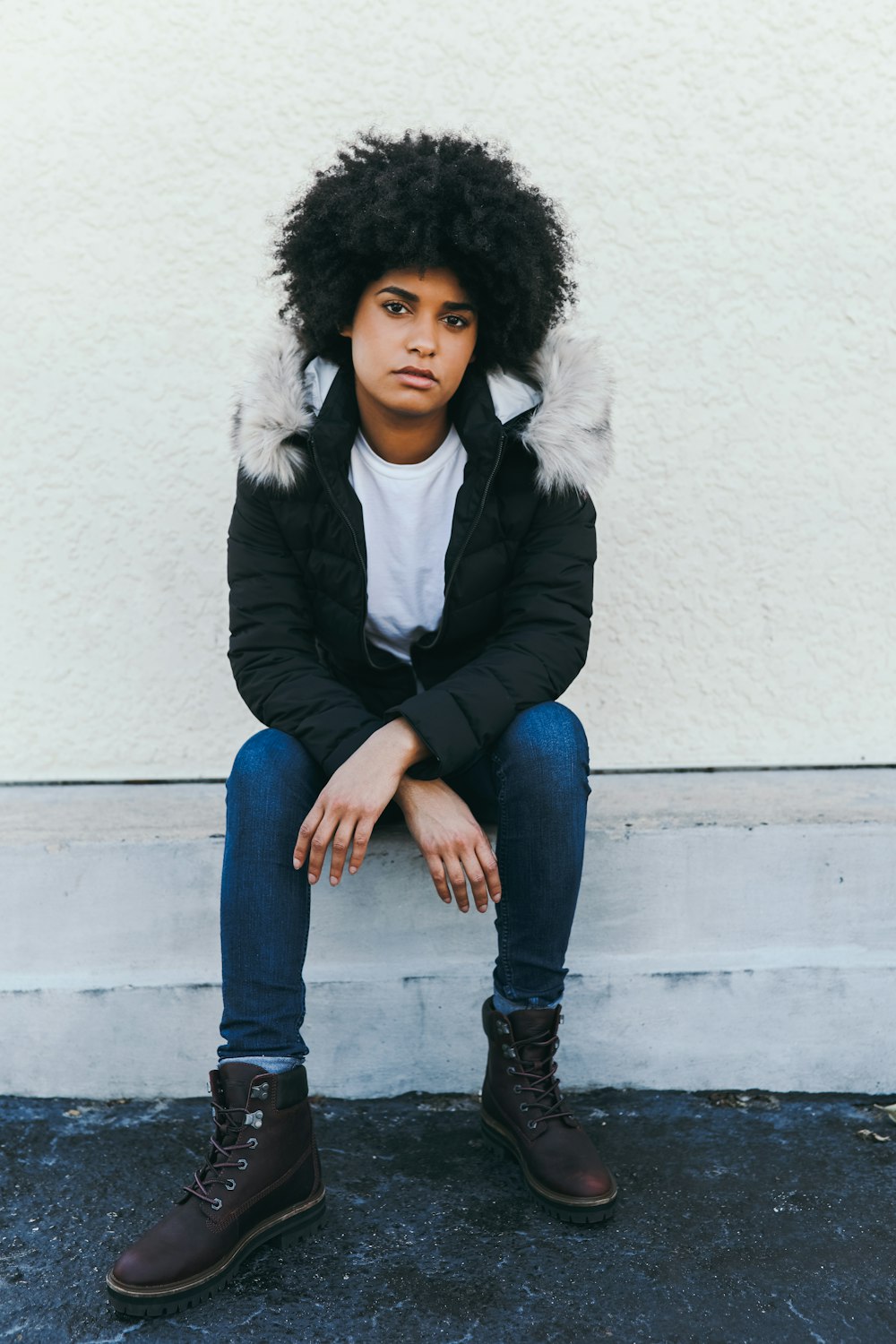 man wearing black jacket sitting on bench