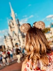 woman wearing golden Mickey Ears at Disneyland