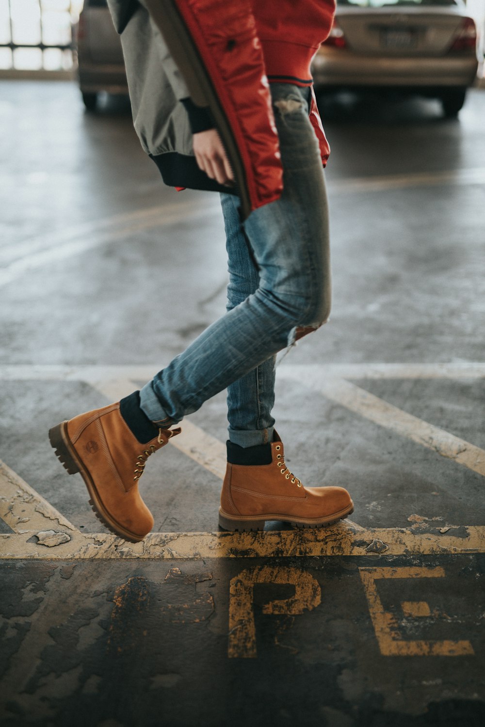 person walking near gray car