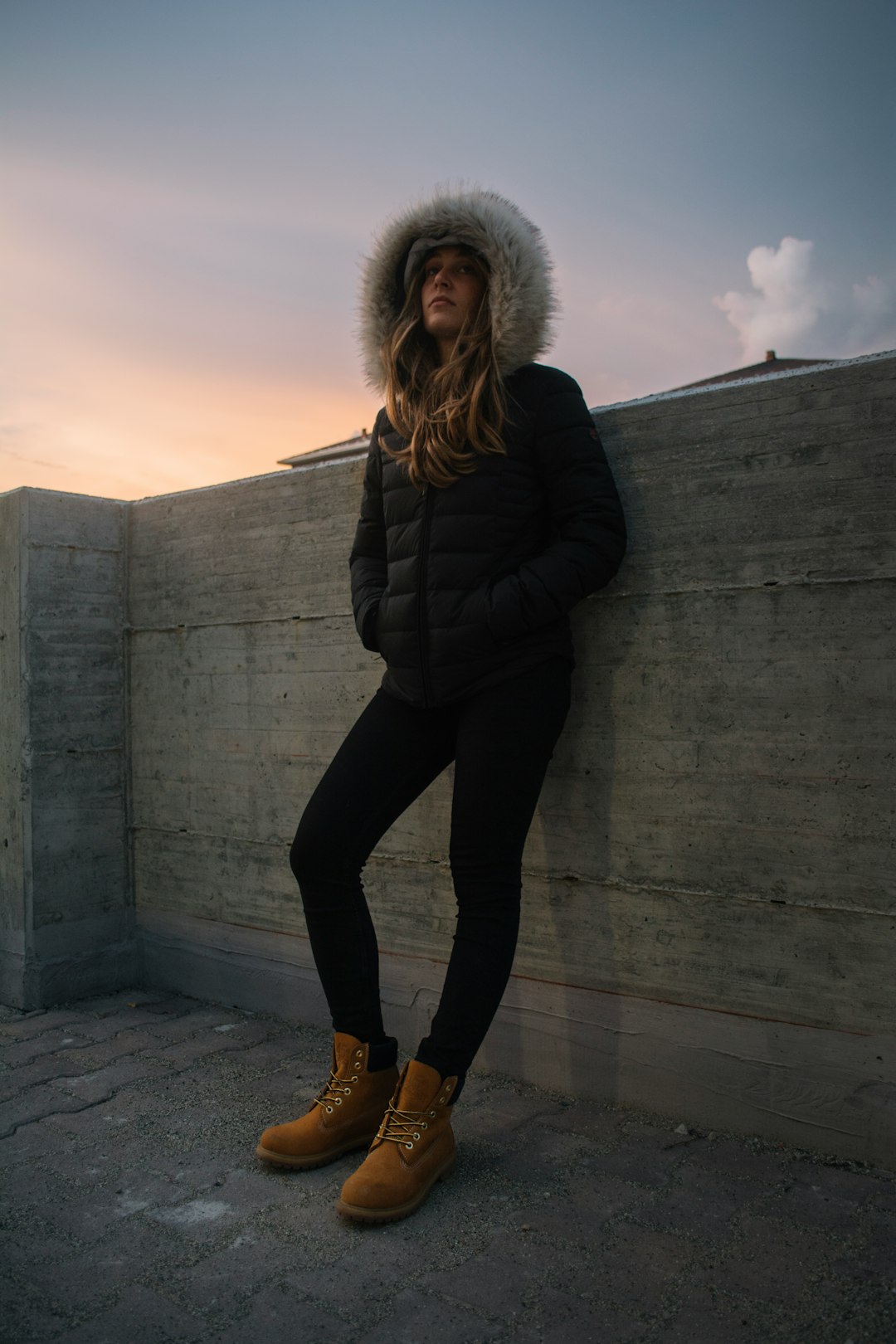 woman leaning on concrete wall