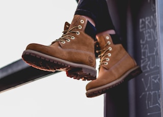 sitting woman wearing black pants and brown work boots